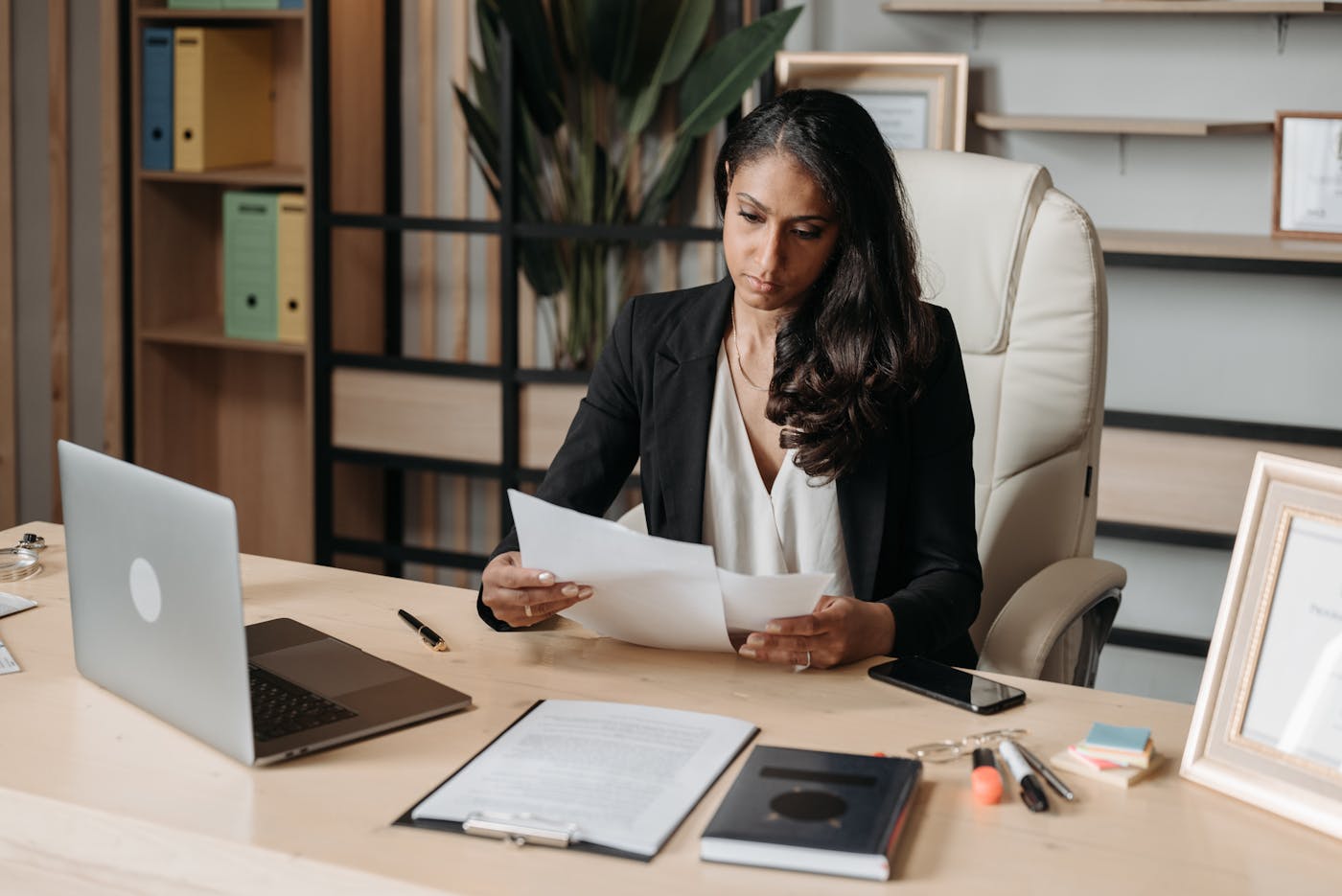 Woman reviewing documents at an office desk