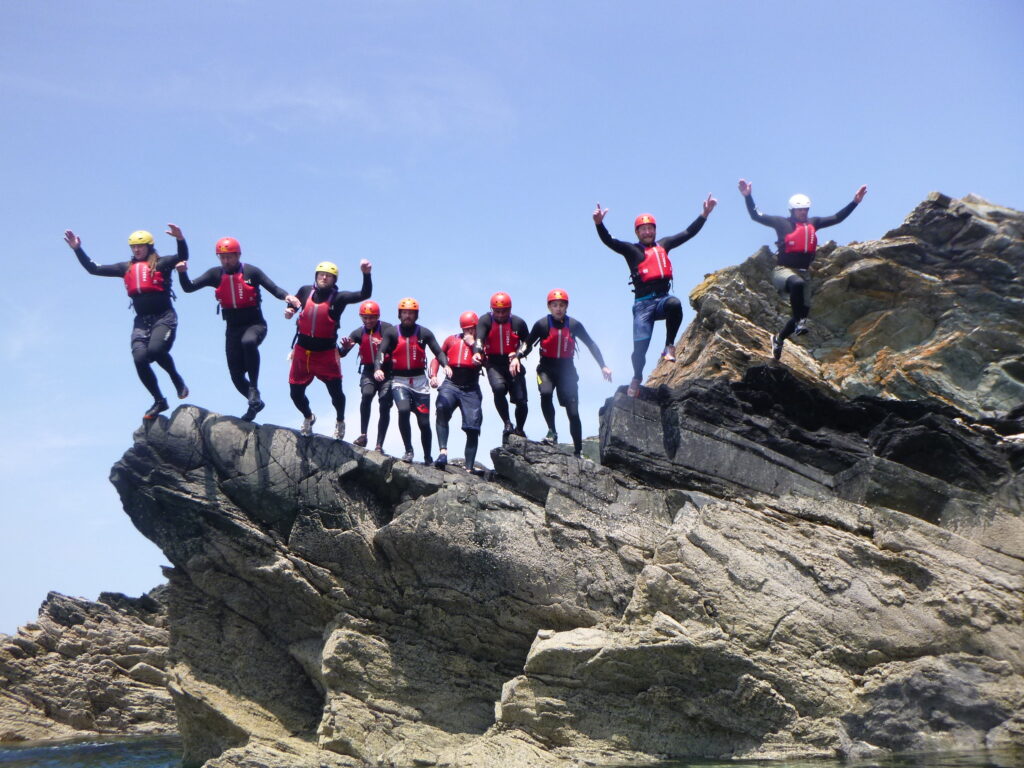Group coasteering on the rocks in Anglesey