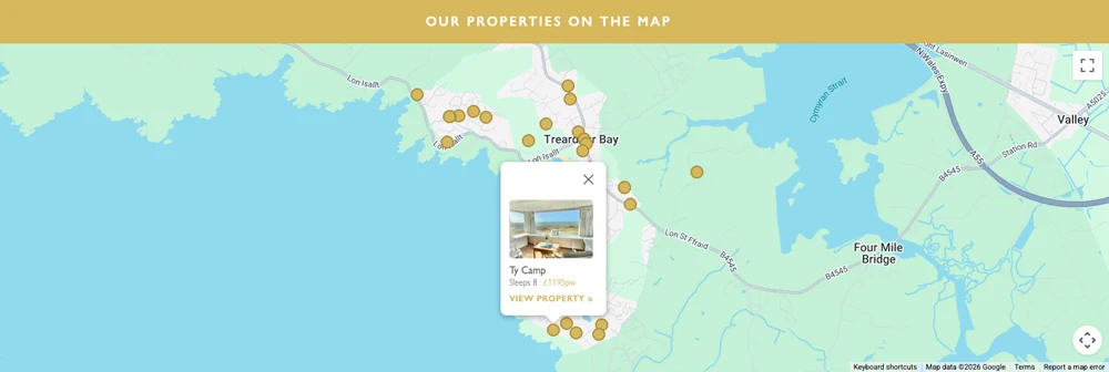 A map of Trearddur Bay with a gold pin for each property and an open card showing one home, the number it sleeps and its weekly price